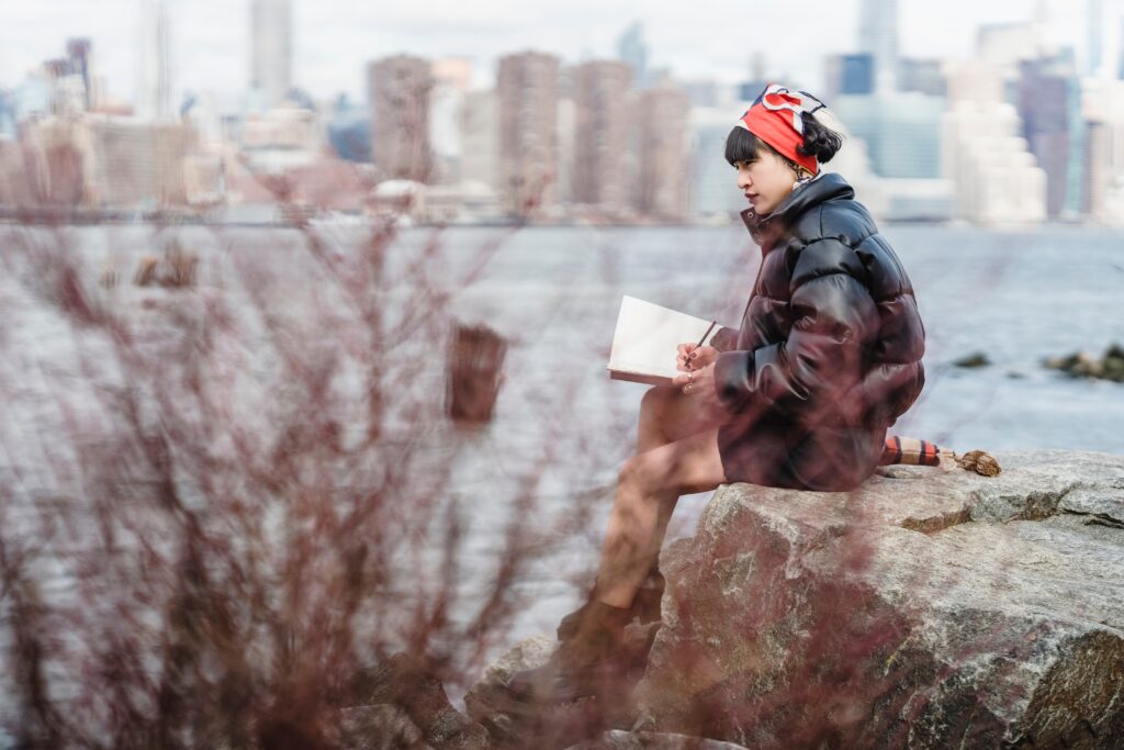 woman sitting with sketchbook drawing
